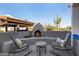 Cozy outdoor living space with a fireplace, perfect for desert evenings at 3333 N 87Th St, Mesa, AZ 85207
