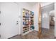 Pantry featuring shelves stocked with food items and a wood door at 3333 N 87Th St, Mesa, AZ 85207