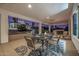 Relax on the covered patio with plush seating, a fire feature, and serene views of the surrounding desert landscape at 3333 N 87Th St, Mesa, AZ 85207