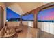 Covered patio with chairs and a table overlooking city lights and mountain views at 3333 N 87Th St, Mesa, AZ 85207