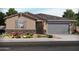Charming single-story home with stone accents, neutral stucco, and a two-car garage at 37091 W Parador Ln, Maricopa, AZ 85138