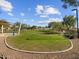 Expansive green space in the community park, featuring a covered picnic area and well-maintained lawn at 3778 N Camden Dr, Florence, AZ 85132