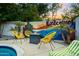 Cozy backyard seating area with a modern fire pit and comfortable yellow chairs, perfect for relaxation and conversation at 4020 N 34Th St, Phoenix, AZ 85018