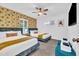 Inviting bedroom showcasing two cozy beds, stylish wallpaper, and a bright, airy atmosphere with ample natural light at 4020 N 34Th St, Phoenix, AZ 85018