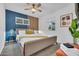 Stylish bedroom featuring modern décor, a ceiling fan, and a comfortable queen-sized bed with ample natural light at 4020 N 34Th St, Phoenix, AZ 85018