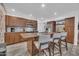 Well-lit kitchen featuring wood cabinets, granite countertops, an island with bar seating, and stainless steel appliances at 4020 N 34Th St, Phoenix, AZ 85018
