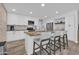 Modern kitchen features white cabinets, granite countertops, stainless appliances, and breakfast bar with seating at 4020 N 34Th St, Phoenix, AZ 85018