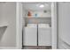 Functional laundry room with white washer and dryer, shelving, and ample space for storage at 4020 N 34Th St, Phoenix, AZ 85018