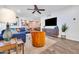 Spacious living room featuring a comfortable blue sofa, accent chair, and seamless flow to the dining area at 4020 N 34Th St, Phoenix, AZ 85018