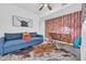 Cozy living space featuring a blue sofa, mid-century desk, and a patterned accent wall at 4020 N 34Th St, Phoenix, AZ 85018