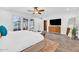 Bright, airy main bedroom with a large bed, ceiling fan, wood-look floors and access to an outdoor patio at 4020 N 34Th St, Phoenix, AZ 85018