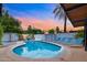 Inviting backyard with a refreshing pool, palm trees, and comfortable lounge chairs for relaxation at 4020 N 34Th St, Phoenix, AZ 85018