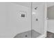 Modern walk-in shower with a glass door, built-in niche, white subway tile and mosaic tile flooring at 4020 N 34Th St, Phoenix, AZ 85018