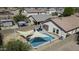 Beautiful home showcasing a private backyard with a sparkling pool and a shaded lounge area at 40845 W Thornberry Ln, Maricopa, AZ 85138