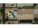 Aerial view of a home with a backyard featuring a pool, shade sails, and outdoor seating at 40845 W Thornberry Ln, Maricopa, AZ 85138