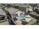 Inviting backyard with a private pool, shade sails, screened-in porch, and comfortable outdoor seating at 40845 W Thornberry Ln, Maricopa, AZ 85138