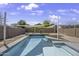 Sparkling pool in a private backyard setting with shade sails creating a perfect oasis for relaxation at 40845 W Thornberry Ln, Maricopa, AZ 85138