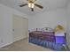 Bedroom features neutral walls, carpet, a wardrobe, and ceiling fan at 40845 W Thornberry Ln, Maricopa, AZ 85138