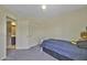 Bedroom features neutral walls, carpet, a teddy bear, and a wardrobe at 40845 W Thornberry Ln, Maricopa, AZ 85138