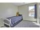 Bright bedroom features a comfy bed, a plush teddy bear, and a window view of the pool at 40845 W Thornberry Ln, Maricopa, AZ 85138