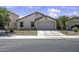 Charming single-story home with a two-car garage and desert landscaping in front yard at 40845 W Thornberry Ln, Maricopa, AZ 85138