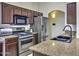 Well-equipped kitchen with stainless steel appliances and granite countertops at 40845 W Thornberry Ln, Maricopa, AZ 85138