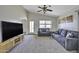 Spacious living room featuring a vaulted ceiling, cozy seating, and lots of natural light at 40845 W Thornberry Ln, Maricopa, AZ 85138
