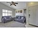 Open living room with comfortable seating, ceiling fan, and bright natural light at 40845 W Thornberry Ln, Maricopa, AZ 85138