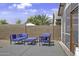 Stylish outdoor seating area featuring comfortable blue chairs, ideal for relaxation and entertaining at 40845 W Thornberry Ln, Maricopa, AZ 85138