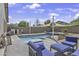 Inviting backyard pool with comfortable lounge seating and shade sail at 40845 W Thornberry Ln, Maricopa, AZ 85138