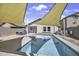Relaxing backyard pool area with clear water and stylish shade covering, perfect for summer days at 40845 W Thornberry Ln, Maricopa, AZ 85138