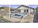 Backyard pool featuring modern design and poolside seating, ideal for outdoor enjoyment at 40845 W Thornberry Ln, Maricopa, AZ 85138