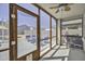 Relaxing screened-in porch offering a tranquil view of the backyard with comfortable seating at 40845 W Thornberry Ln, Maricopa, AZ 85138
