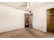 This bedroom features a ceiling fan, a closet, and wall decor at 4343 E Union Hills Dr, Phoenix, AZ 85050