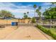 View of a concrete driveway with palm trees in the background and a chain link fence on either side at 4343 E Union Hills Dr, Phoenix, AZ 85050