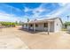 An exterior view of a single story home with ample parking and a covered walkway at 4343 E Union Hills Dr, Phoenix, AZ 85050