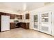 Well-lit kitchen with wooden cabinets, white appliances, and backyard access at 4343 E Union Hills Dr, Phoenix, AZ 85050