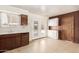Kitchen features white appliances, wood cabinetry, a window, and a door to the backyard at 4343 E Union Hills Dr, Phoenix, AZ 85050