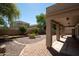 Serene backyard featuring manicured landscaping, a stone path, and a covered patio, ideal for entertaining at 4349 E Windsor Ct, Gilbert, AZ 85296