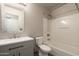 Clean bathroom with a modern vanity, toilet, and shower-tub combination, all designed for comfort and functionality at 4349 E Windsor Ct, Gilbert, AZ 85296