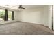 Generously sized bedroom featuring neutral carpeting and a window dressed with elegant gray curtains at 4349 E Windsor Ct, Gilbert, AZ 85296
