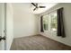 Inviting bedroom with carpet, a ceiling fan, and large windows adorned with dark curtains, offering a cozy ambiance at 4349 E Windsor Ct, Gilbert, AZ 85296