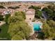 Aerial view of community pool and neighboring townhomes boasting lush landscaping and mature trees at 4349 E Windsor Ct, Gilbert, AZ 85296