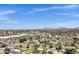 Expansive aerial view showcasing the neighborhood's lush greenery, mountain views, and clear blue sky at 4645 E Cambridge Ave, Phoenix, AZ 85008