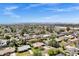 Wide aerial perspective captures the layout of a neighborhood with homes, trees, and city buildings in the distance at 4645 E Cambridge Ave, Phoenix, AZ 85008