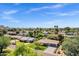 Expansive aerial view showcases a neighborhood with single-story homes, lush trees, and mountain views at 4645 E Cambridge Ave, Phoenix, AZ 85008
