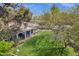 Serene backyard featuring a covered patio with seating, lush greenery, and a mature shade tree at 4645 E Cambridge Ave, Phoenix, AZ 85008