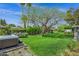 Wide shot of the backyard with a hot tub, swing set, and a mature shade tree, providing a serene outdoor retreat at 4645 E Cambridge Ave, Phoenix, AZ 85008