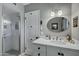 Bright bathroom with a stand-up shower, a white vanity with elegant fixtures, and neutral-toned walls at 4645 E Cambridge Ave, Phoenix, AZ 85008