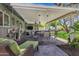 Cozy covered patio with comfortable seating, a dining table, and a view of the green backyard and hot tub at 4645 E Cambridge Ave, Phoenix, AZ 85008